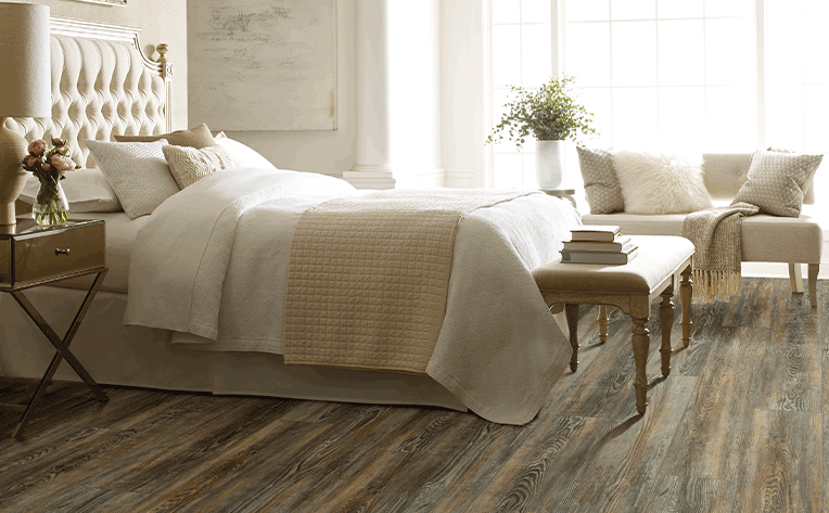 multi-tone vinyl plank flooring in bedroom with cream colored decor